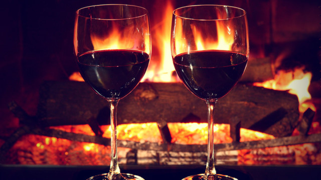two-glasses-of-wine-in-front-of-fireplace