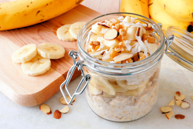 Overnight Oats With Bananas And Nuts In Snap Lid Glass Jar On Wh